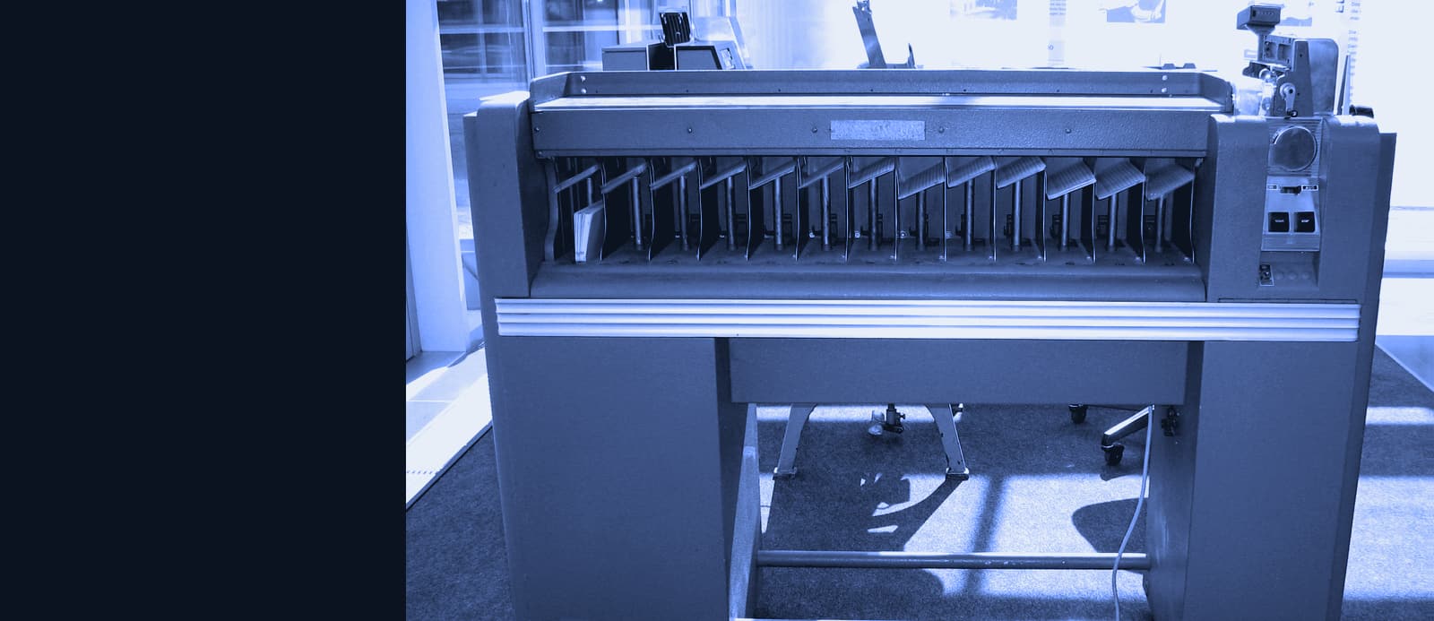 An IBM punched-card sorter with cards in its pockets