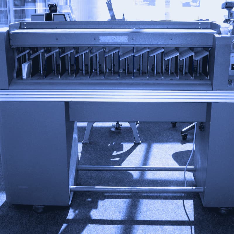 An IBM punched-card sorter with cards in its pockets