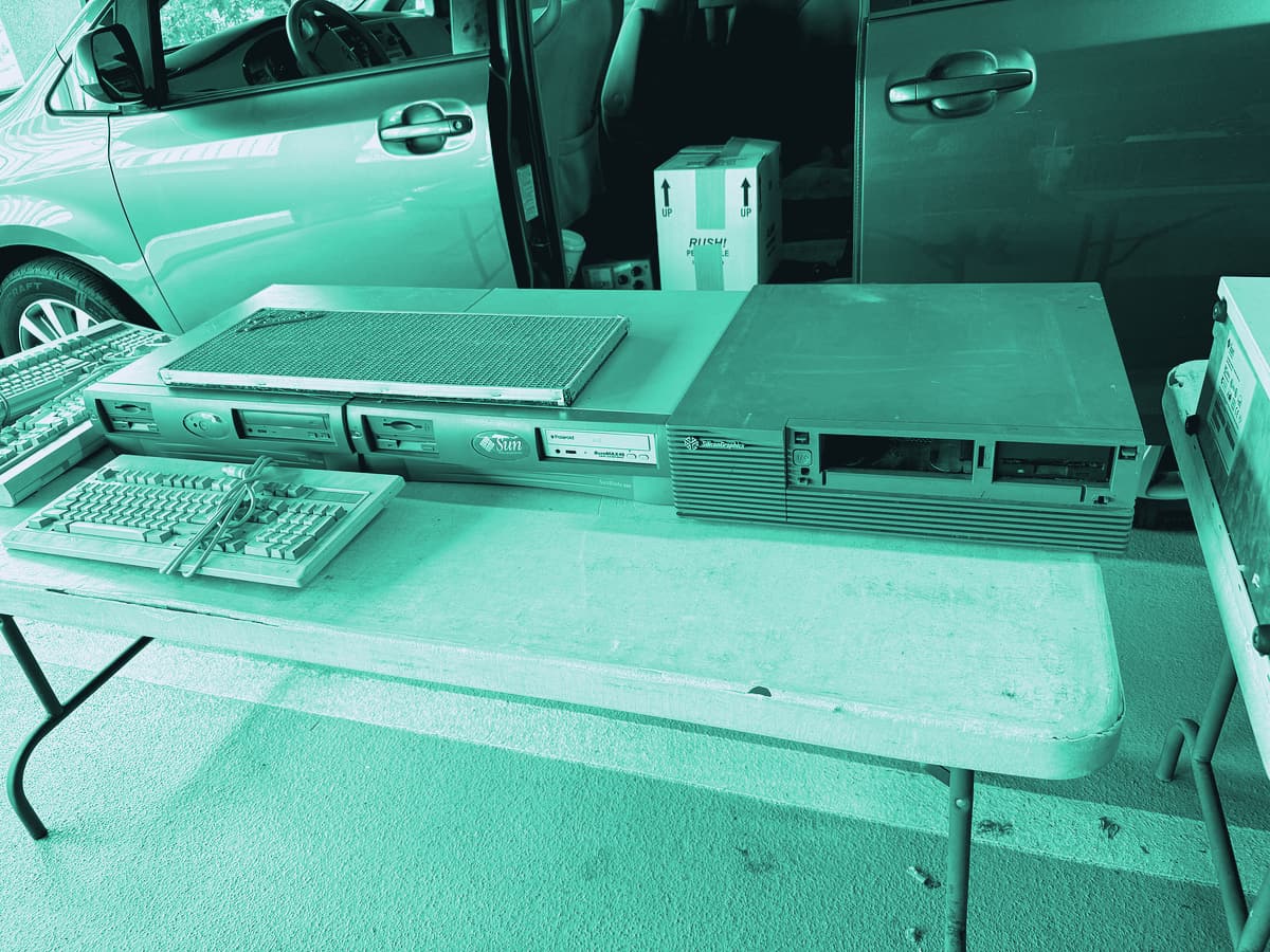 Old Sun and Silicon Graphics workstations for sale on a folding table at the MIT Flea