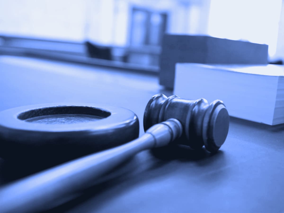 A judge's gavel on a courtroom bench